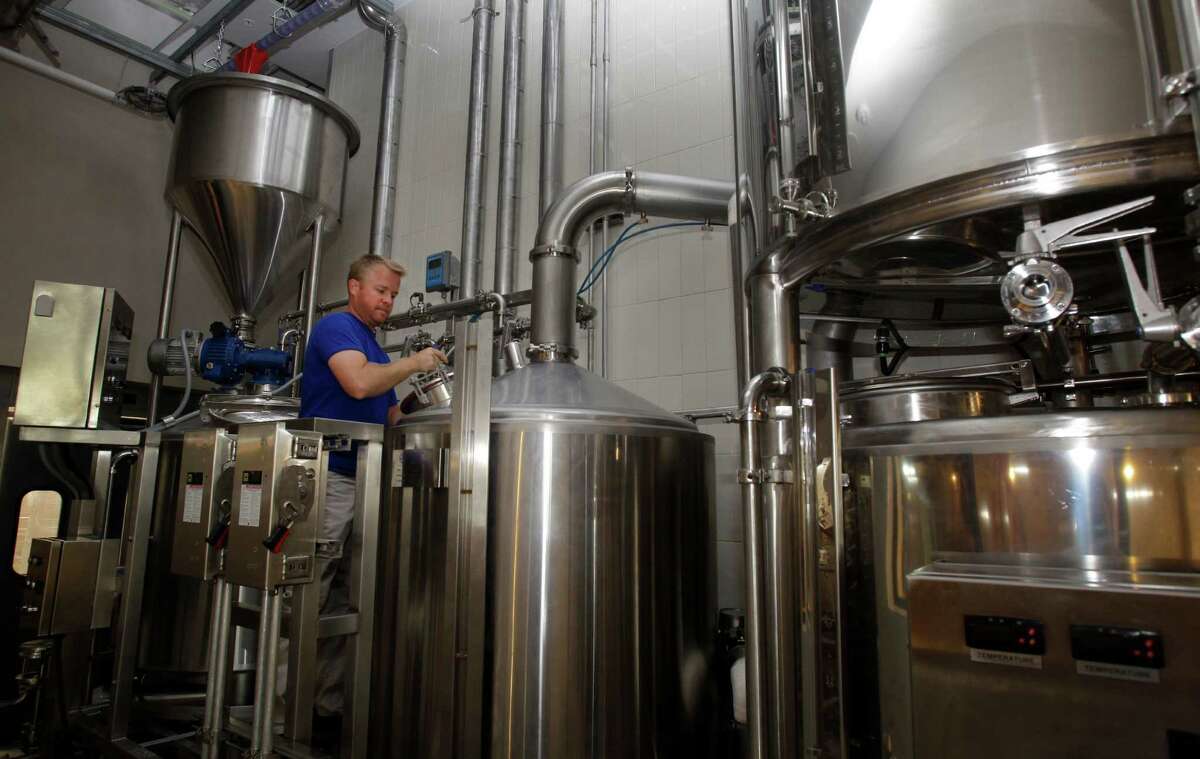 Dave Ohmer, brewmaster, works the brew house at Whole Foods Market.
