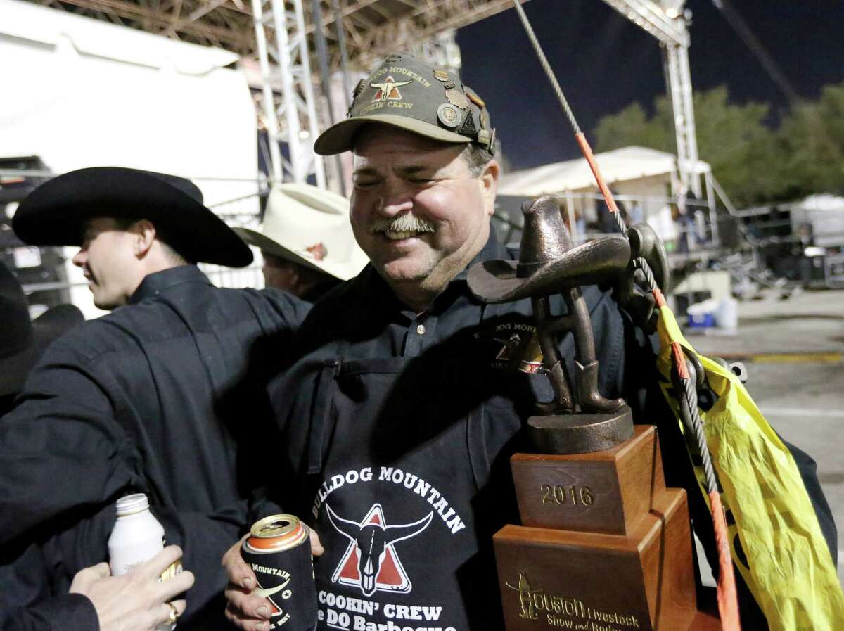 Mike Wells, center, of "Bulldog Mountain Cookin' Crew 2," who won "Grand Champion Overall," smiles backstage at the Houston Livestock Show and Rodeo's World's Championship Barbecue Contest Saturday, Feb. 27, 2016, in Houston. ( Jon Shapley / Houston Chronicle )