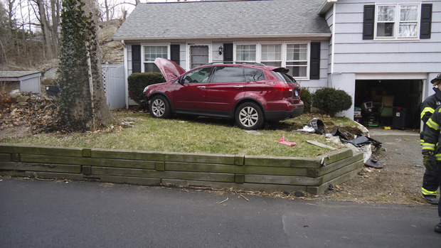 Woman hospitalized after car crashes into stone wall