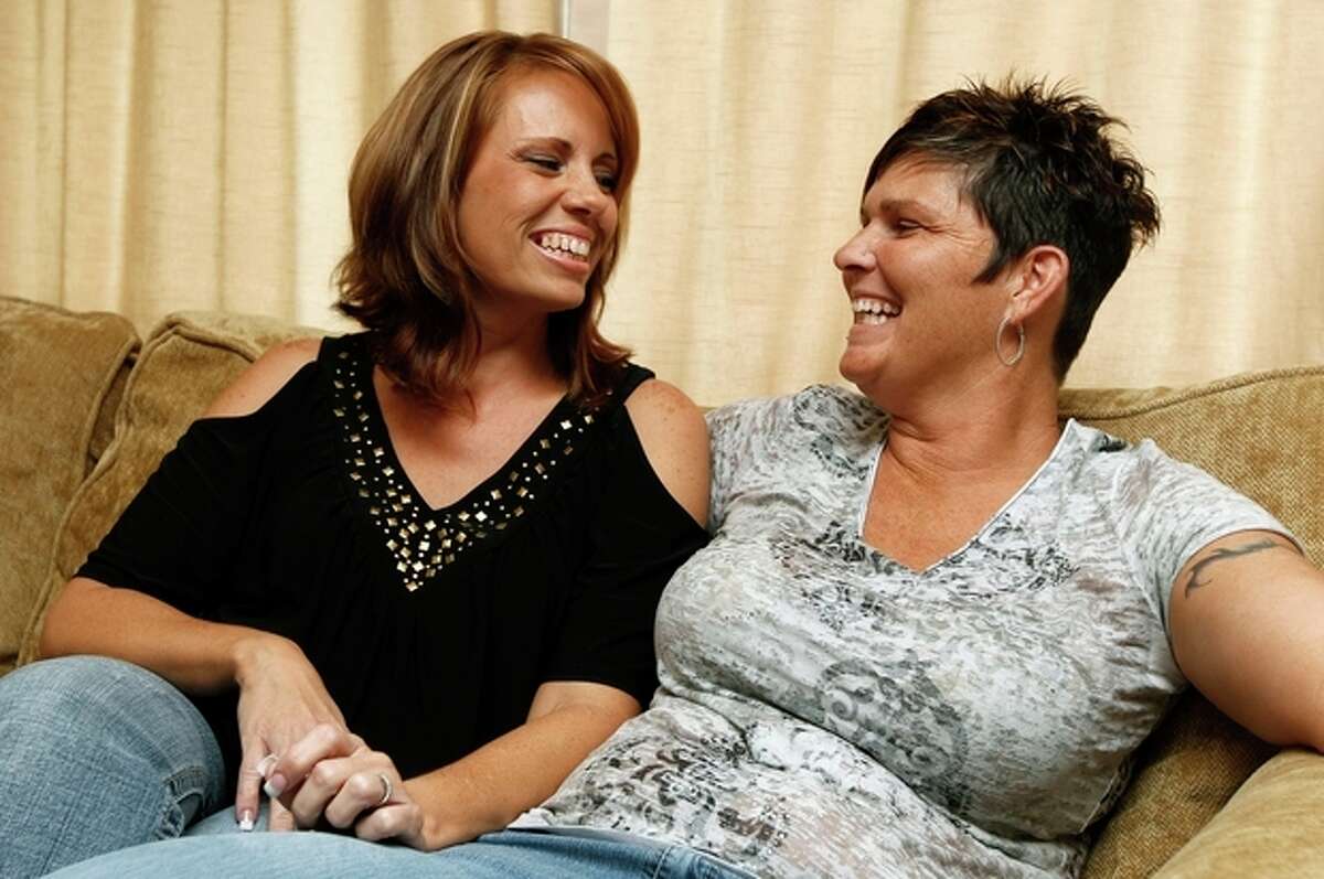 Melissa Patrick, right, and her partner Sheila Barnett share a laugh during an interview Tuesday, Nov. 8, 2011, in Port Charlotte, Fla. The couple won a dream wedding on Facebook and will be married on Nov. 11, in New York City. As Barnett and Patrick pack their warm clothes and nearly identical dresses for the ceremony , they are trying not to think about this one fact: when they get home to Florida after their whirlwind, fairy-tale weekend, their marriage won't be legal in Florida. (AP Photo/Chris O'Meara)