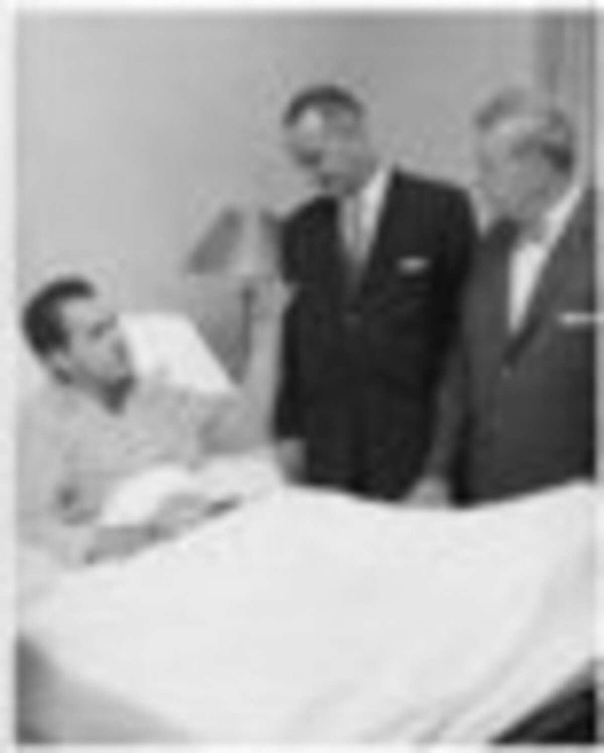 FILE - In this August 1960 file photo provided by Walter Reed Army Medical Center, Presidential candidate Richard M. Nixon is visited at Walter Reed Army Medical Center by Vice Presidential candidate Sen. Lyndon Johnson, Senator John Kennedy's running mate, and Senator Everett Dirksen. Nixon spent two weeks at Walter Reed recovering from a bacterial staph infection. (AP Photo/Walter Reed Army Medical Center, ho)