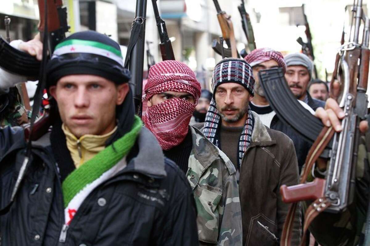 Syrian rebels march in a show of strength during a demonstration in Idlib, Syria, Friday, Feb. 10, 2012. (AP Photo)