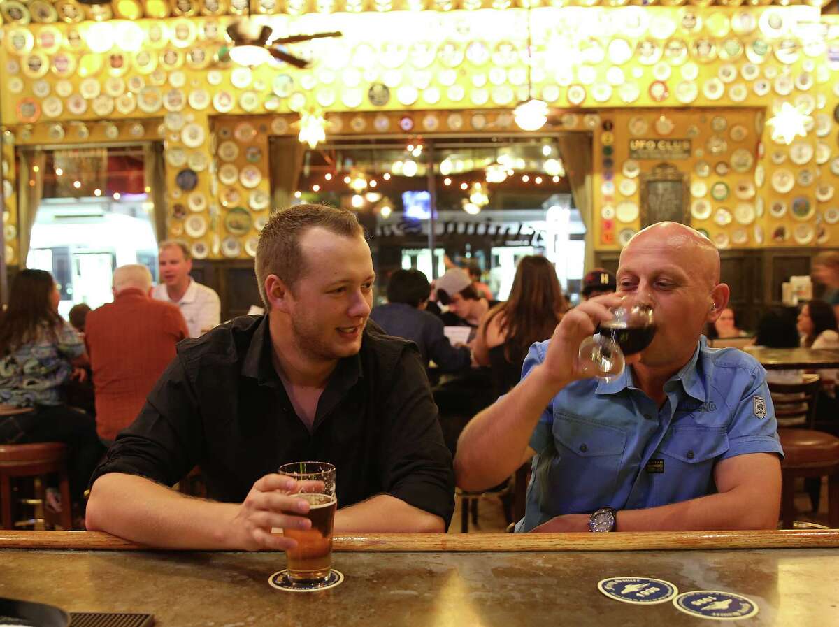 Andreas Willing, left, and Bertrand Meiss chat over beers at Flying Saucer on Saturday, Oct. 10, 2015, in Houston. 