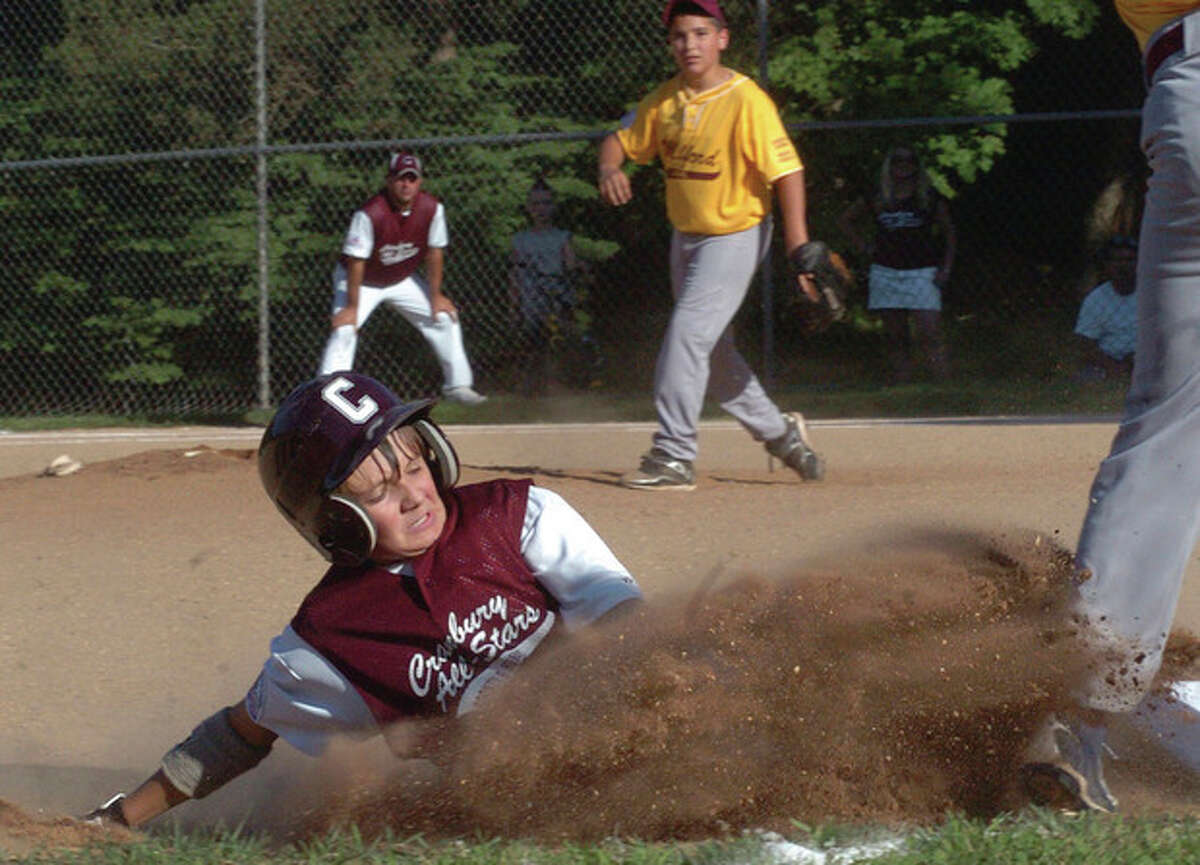 Hour photo/Matthew Vinci Eddie McCabe of the Cranbury Bronco all-stars slides safely into third base during Friday?•s PONY Baseball district tournament game against Milford at Tim Devine Field in Norwalk. It was the opener of a best-of-three series. Norwalk won, 10-9.