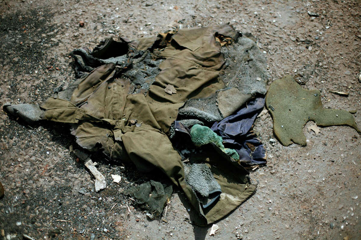 In this image taken during an official visit organized by the Malian army to the town of Konna, some 680 kilometers (430 miles) north of Mali's capital Bamako, Saturday, Jan. 26, 2013, a jacket lays on the ground of a destroyed base used by islamist rebels. One wing of Mali's Ansar Dine rebel group has split off to create its own movement, saying that they want to negotiate a solution to the crisis in Mali, in a declaration that indicates at least some of the members of the al-Qaida linked group are searching for a way out of the extremist movement in the wake of French air strikes. (AP Photo/Jerome Delay)