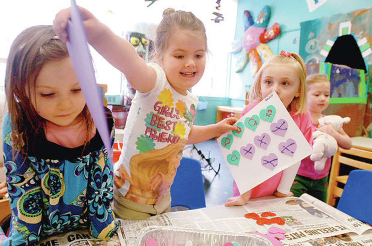 Photo by Erik Trautmann Students from Wilton Parks and Recreation's "On School Road" program, from left, Erin Kelly, Arielel Coco Preller, Mya Salvino and Alexis Onthank, create art projects Wednesday as part of the program's daily preschool activities.
