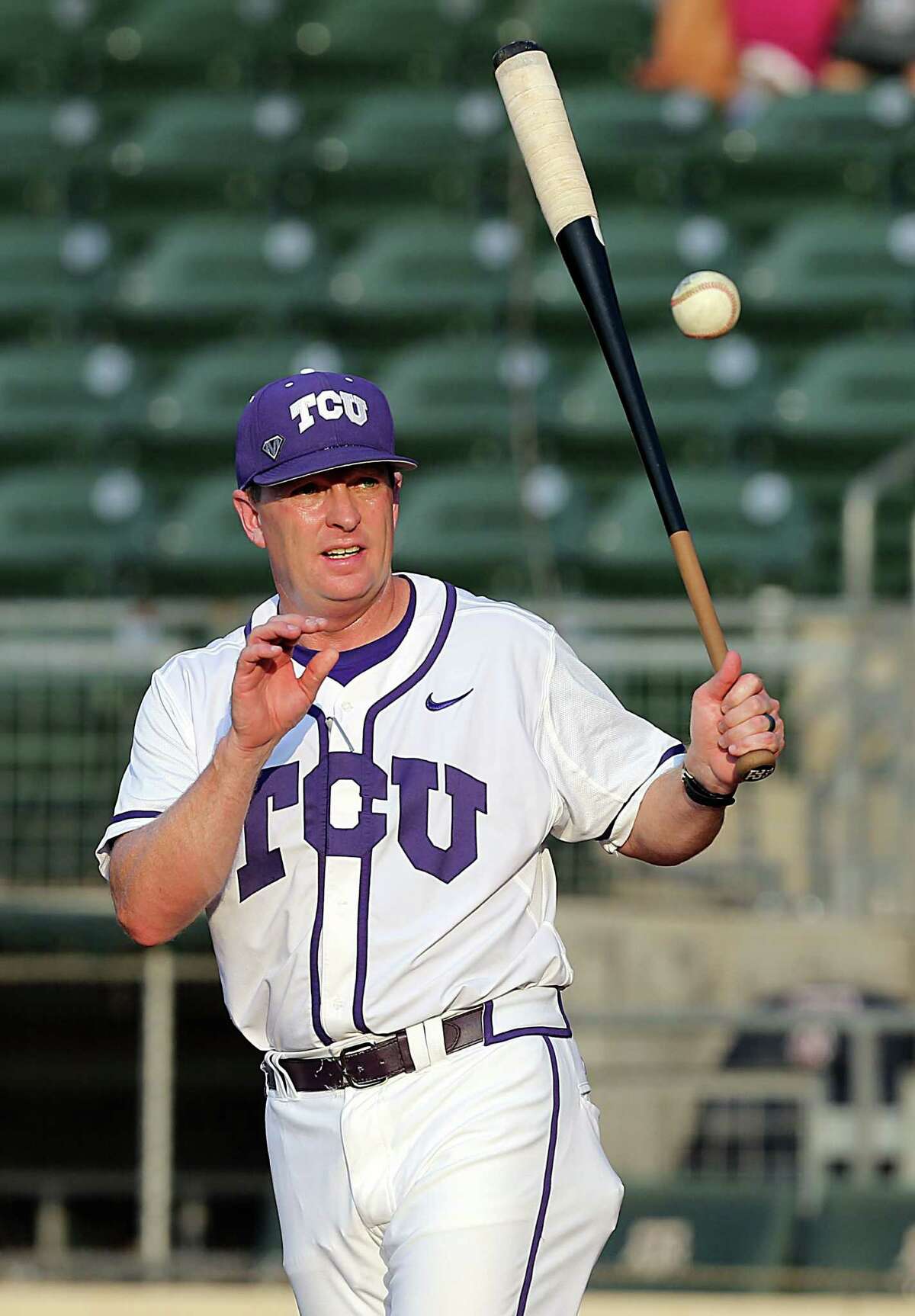 TCU head coach Jim Schlossnagle takes infield practice with his team before the start of a NCAA college baseball super regional tournament game against Texas A&M on June 11, 2016, in College Station.