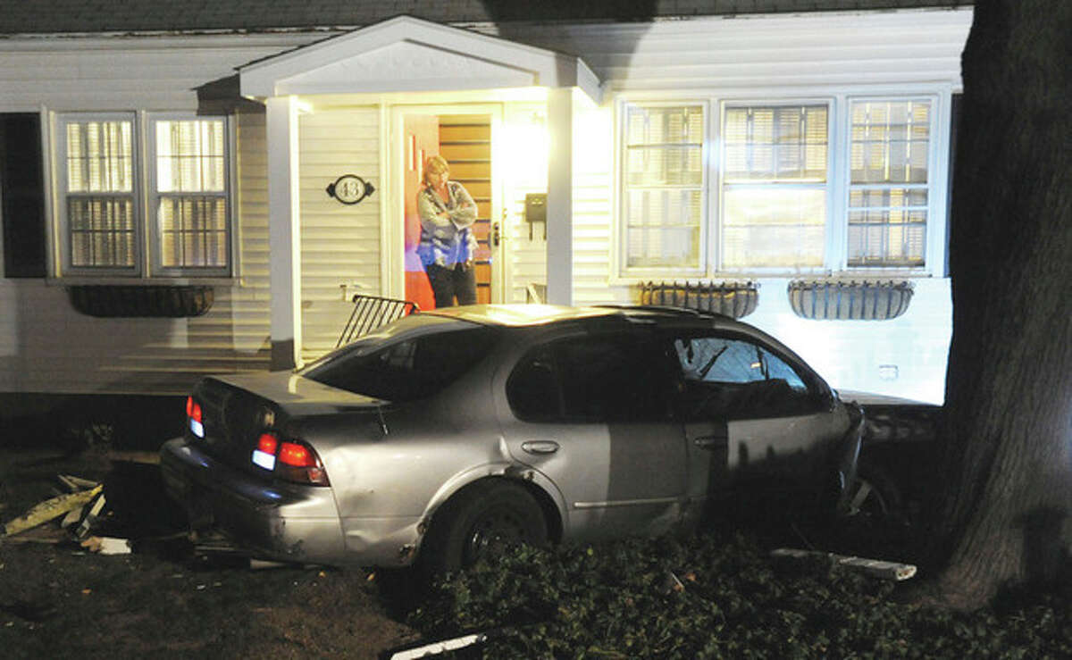 Hour photo/John Nash - A car allegedly used in the armed robbery of a jewelry on Westport Ave., was involved in a car crash on George Ave. in Norwalk on Friday night. One suspect was apprehended with the help of a police dog while two other suspects remained uncaptured early Friday evening.