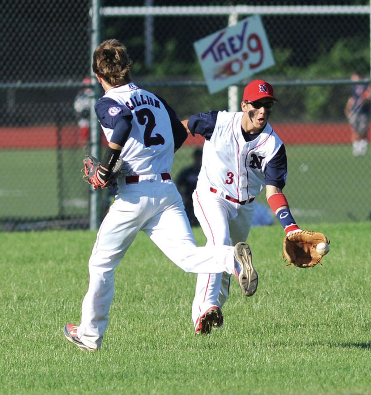 Hour Photo/John Nash Norwalk center fielder Ed Petrillo, right, collects the ball on a bounce after a Texas League single fell in between him and shortstop Alex Scallion during Tuesday?•s Babe Ruth game at Brien McMahon.