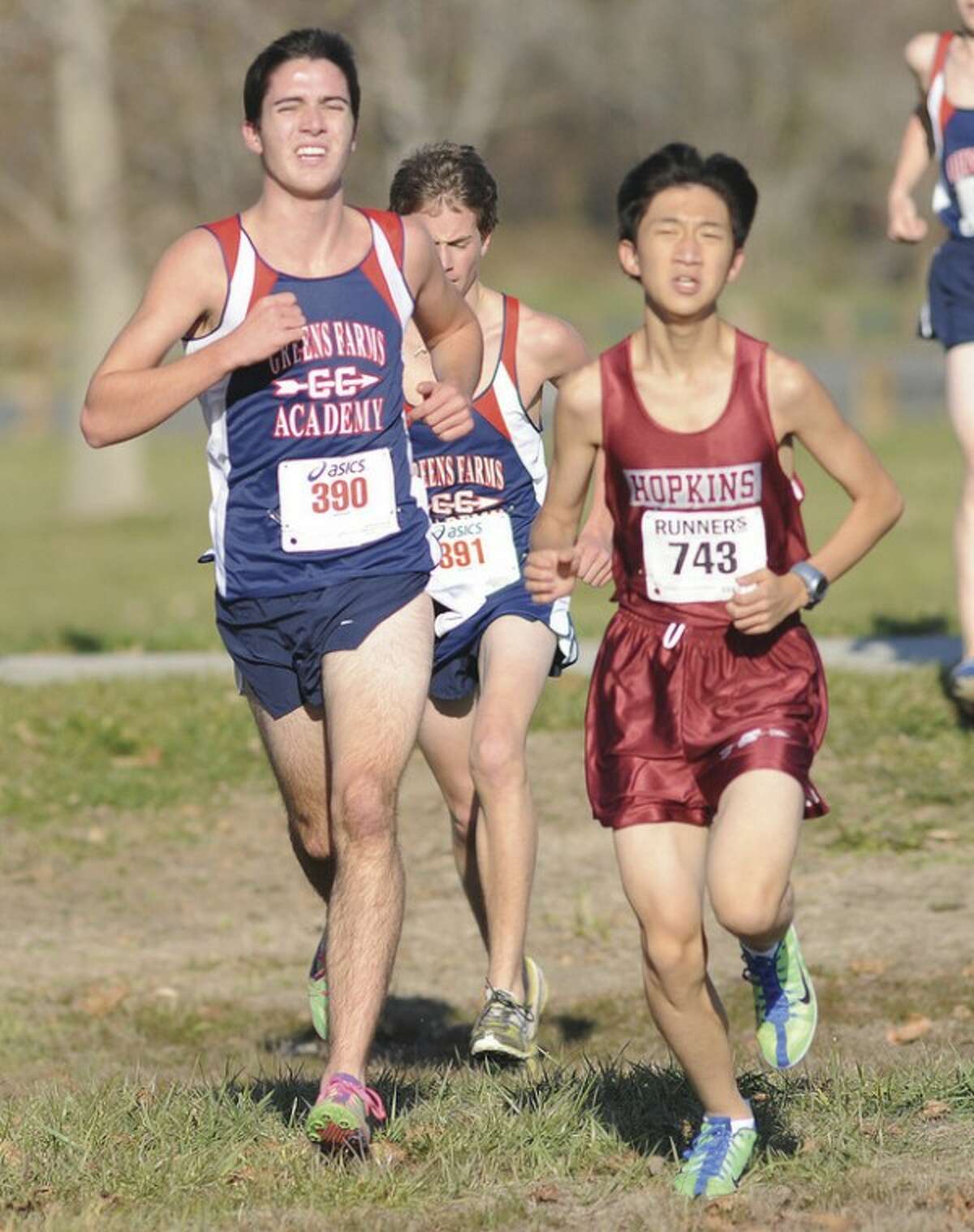 Hour photo/John Nash Peter Maturo, left, and Andrew McCarthy of Greens Farms Academy keep pace with a Hopkins runner during Monday's FAA cross country championship meet in Westport. Maturo finished fifth and McCarthy sixth in the meet. The defending champion GFA boys finished third.