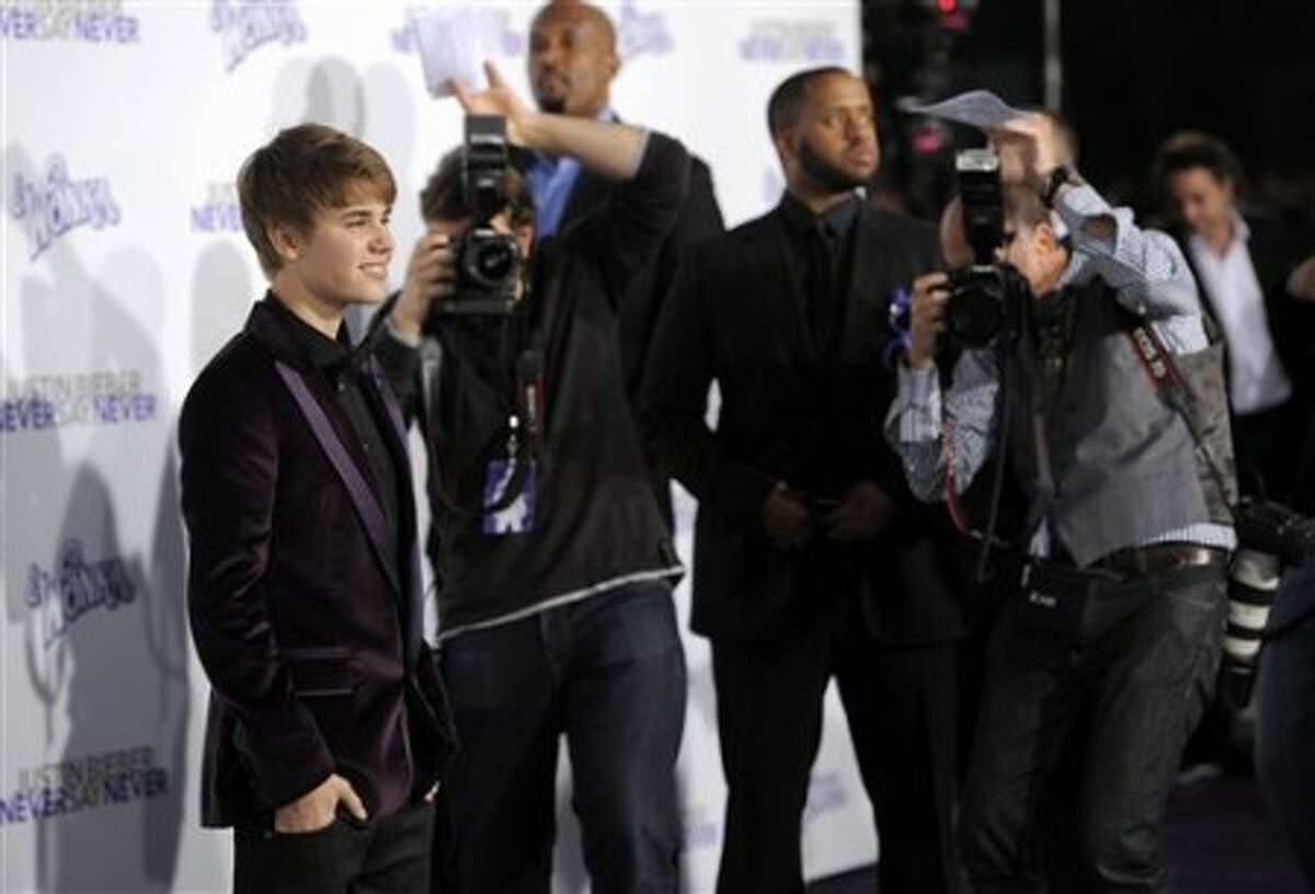 Justin Bieber, subject of the documentary film "Justin Bieber: Never Say Never," poses at the premiere of the film in Los Angeles, Tuesday, Feb. 8, 2011. (AP Photo/Chris Pizzello)