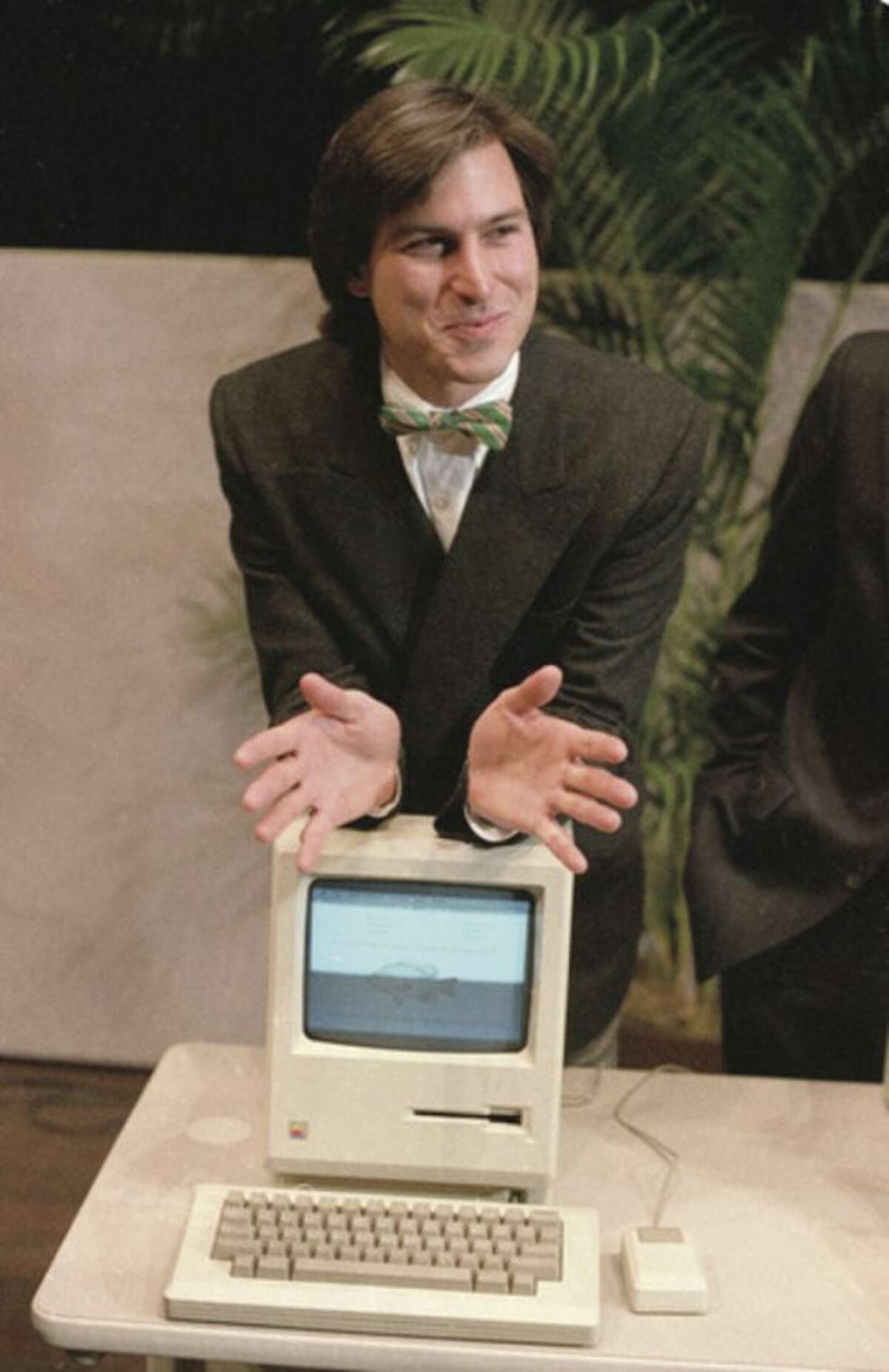 FILE - In this Jan. 24, 1984, file photo, Steve Jobs, chairman of the board of Apple Computer, leans on the new