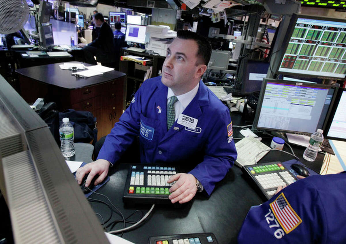 Specialist James Sciulli works at his post on the floor of the New York Stock Exchange Monday, Feb. 27, 2012. U.S. stocks pulled back Monday from some of their highest levels in three and a half years. (AP Photo/Richard Drew)