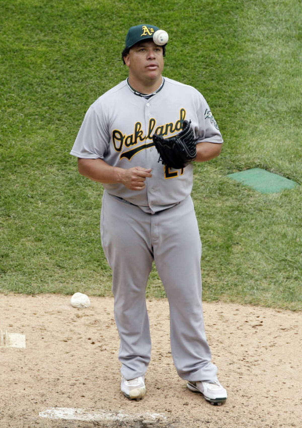 FILE - In this Aug. 12, 2012, file photo, Oakland Athletics starter Bartolo Colon tosses the ball after Chicago White Sox's Gordon Beckham hit a two-run single during the sixth inning of a baseball game in Chicago. Major League Baseball says it is "extremely disappointed" about a new report that says records from an anti-aging clinic in the Miami area link Alex Rodriguez and other players to the purchase of performance-enhancing drugs. The Miami New Times said in a story Tuesday, Jan. 29, 2013, that it had obtained files through an employee at a recently closed clinic called Biogenesis. Other players named by the publication as appearing in the records include Colon, Melky Cabrera, Gio Gonzalez and Nelson Cruz.(AP Photo/Nam Y. Huh, File)