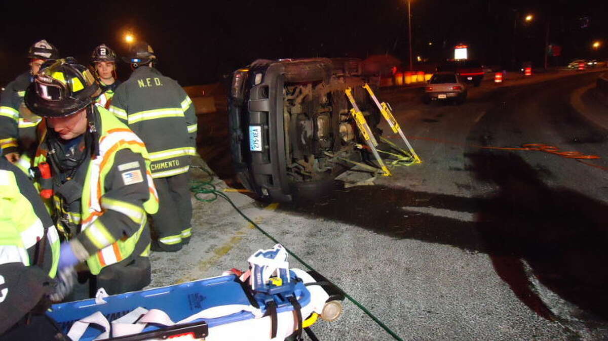 Norwalk firefighters work at the scene of an accident Saturday night.