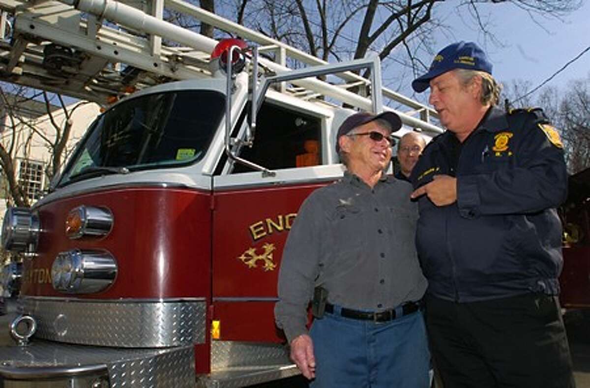 Rowayton volunteer firefighter for 38 years, Tom Murray, receives a thank you from Panamanian Fire Captain Luis Endara after the Rowayton Volunteer Fire Dpartment donated their 1982 ladder truck to Panama Friday. Hour photo / Erik Trautmann