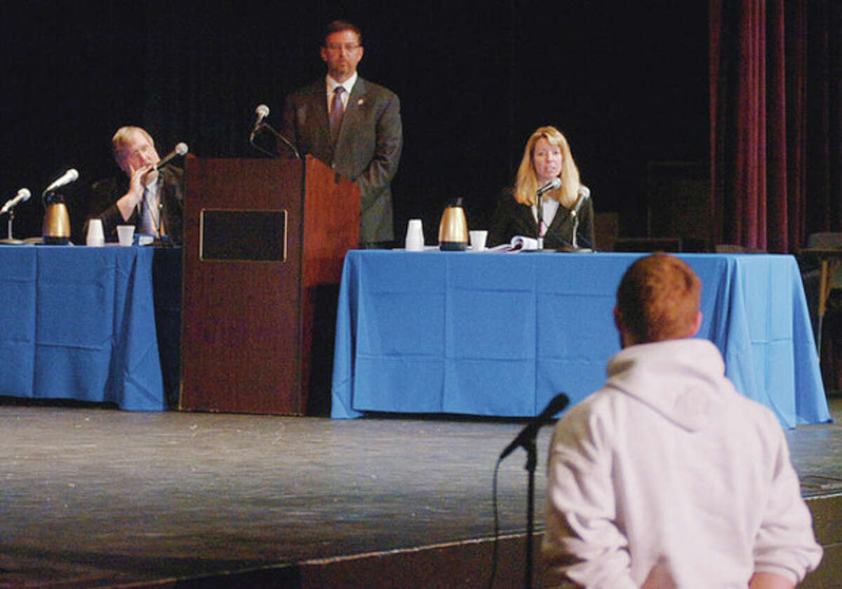 Photo by Erik Trautmann State's Attorney Leon Dalbec and Attorney Kirsten Coffina listen Tuesday as moderater Rod Kowalski, center, of the Fairfield County Bar Association, answers students questions following a public education program exposing Westhill High School students to the judicial process.