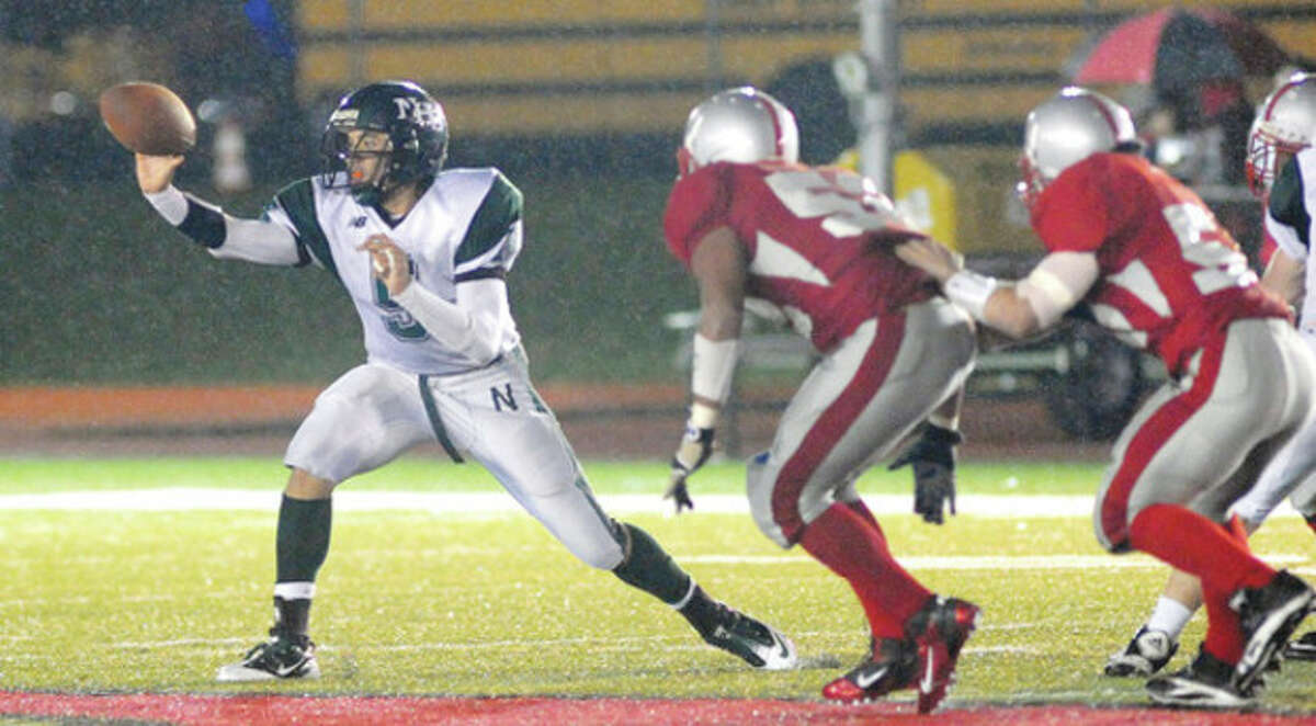 Hour Photo/John Nash Norwalk quarterback Delshawn Wilson pitches the ball to an unseen running back on an option play during Tuesday's win over Conard in the Class LL state football quarterfinals. Wilson likes to talk about 'turning the page,' but with a trip to the semifinals looming on Saturday these Bears are writing a new chapter in NHS football history.