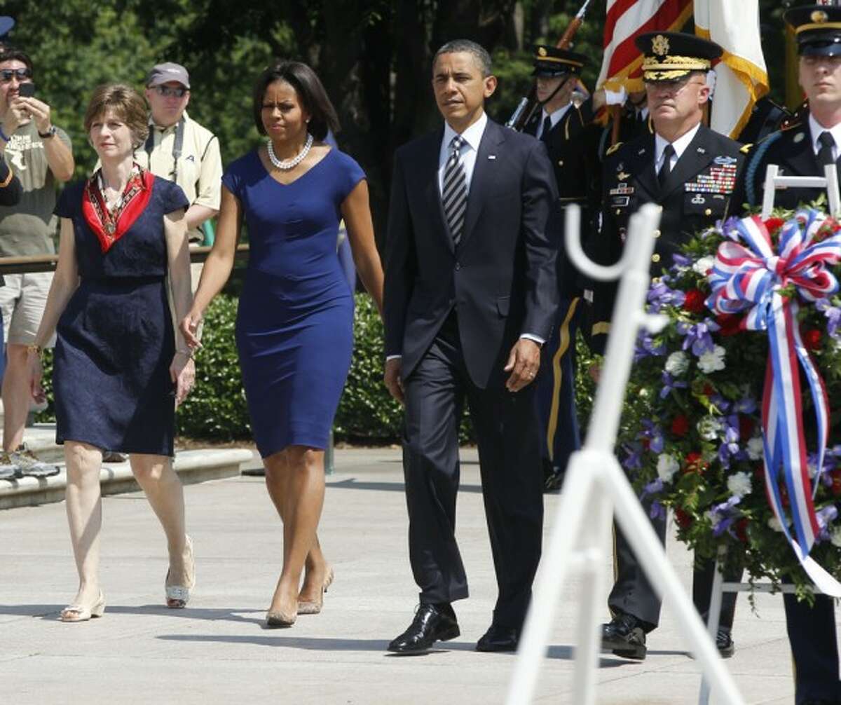 President Barack Obama walks with Maj. Gen. Karl Horst, commander of the U.S. Army Military District of Washington, his wife Nancy, and first lady Michelle Obama before placing a wreath at the Tomb of the Unknowns on Memorial Day at Arlington National Cemetery, Monday, May 30, 2011. (AP Photo/Charles Dharapak)