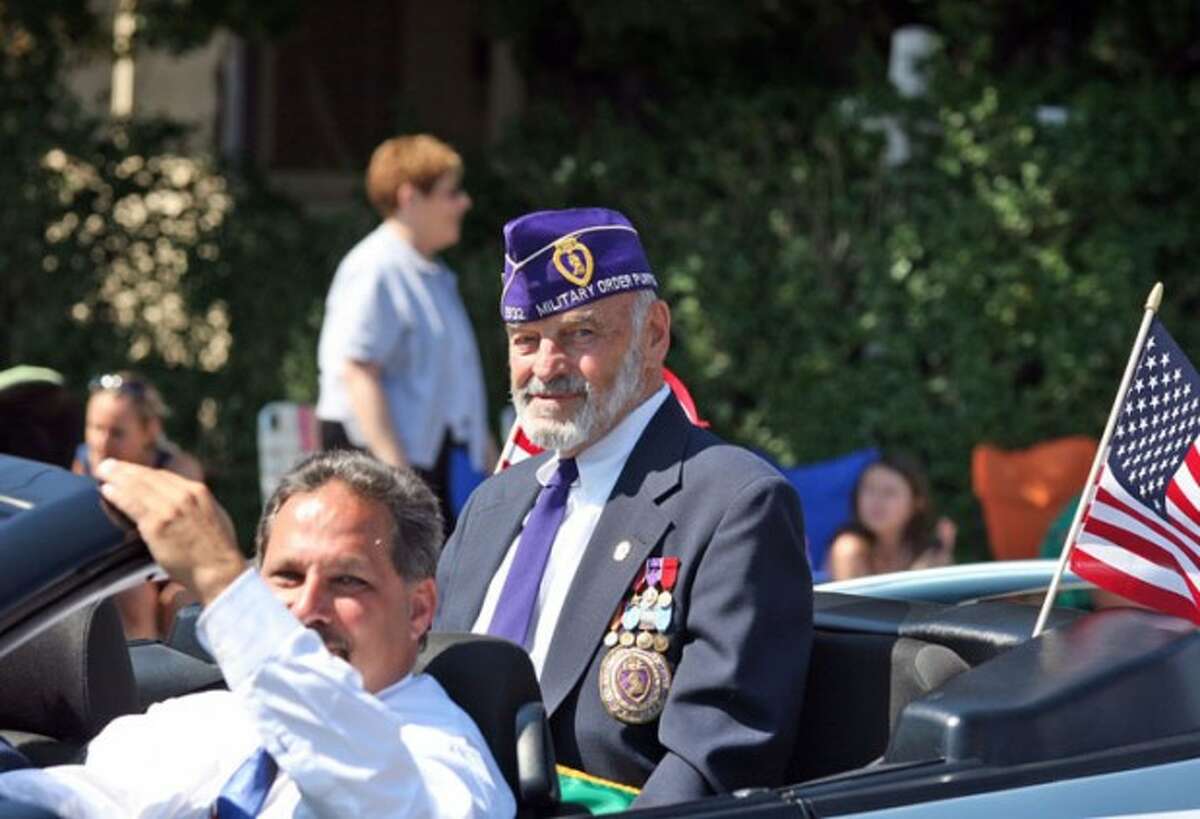 Grand Marshal Phil Marzolf rides in a car driven by Andy Garfunkel in Norwalk''s annual Memorial Day parade Monday morning. Hour Photo / Danielle Robinson
