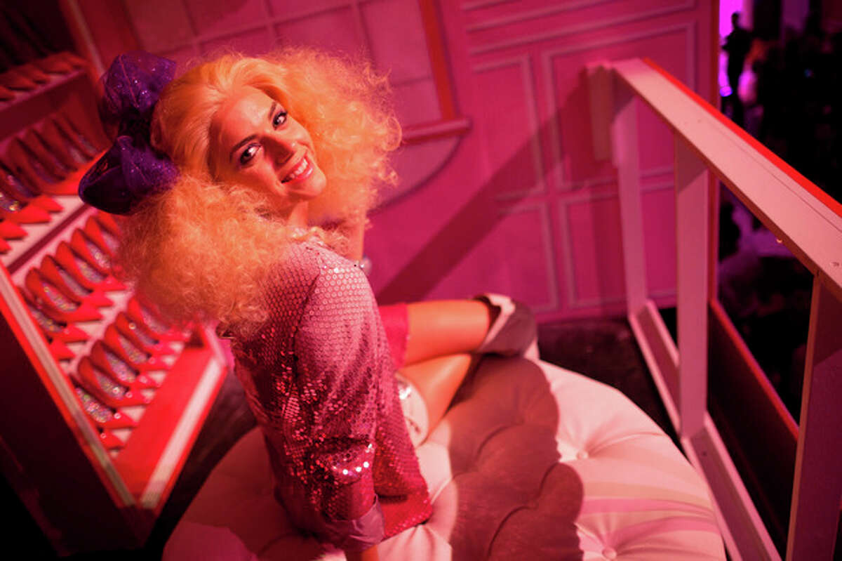 A model dressed as a Barbie doll poses for a picture at the Barbie Dream House party during Fashion Week in New York, Friday, Feb. 10, 2012. (AP Photo/John Minchillo)