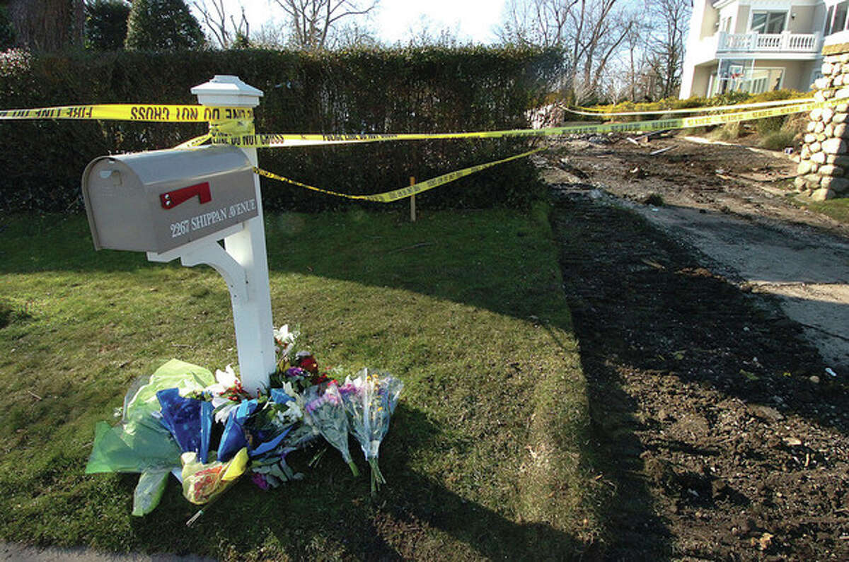 Hour Photo/ Alex von Kleydorff. Flowers placed at the base of the mailbox for 2267 Shippan Ave where a fatal fire killed five people Christmas Day.