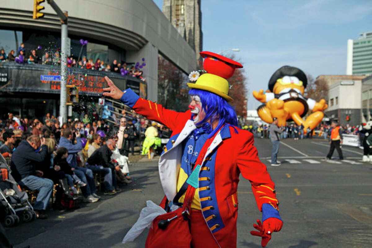 Clown Charles Bia preforms a trick with glitter during the annual UBS Parade Spectacular in Stamford Sunday afternoon. Hour Photo / Danielle Robinson