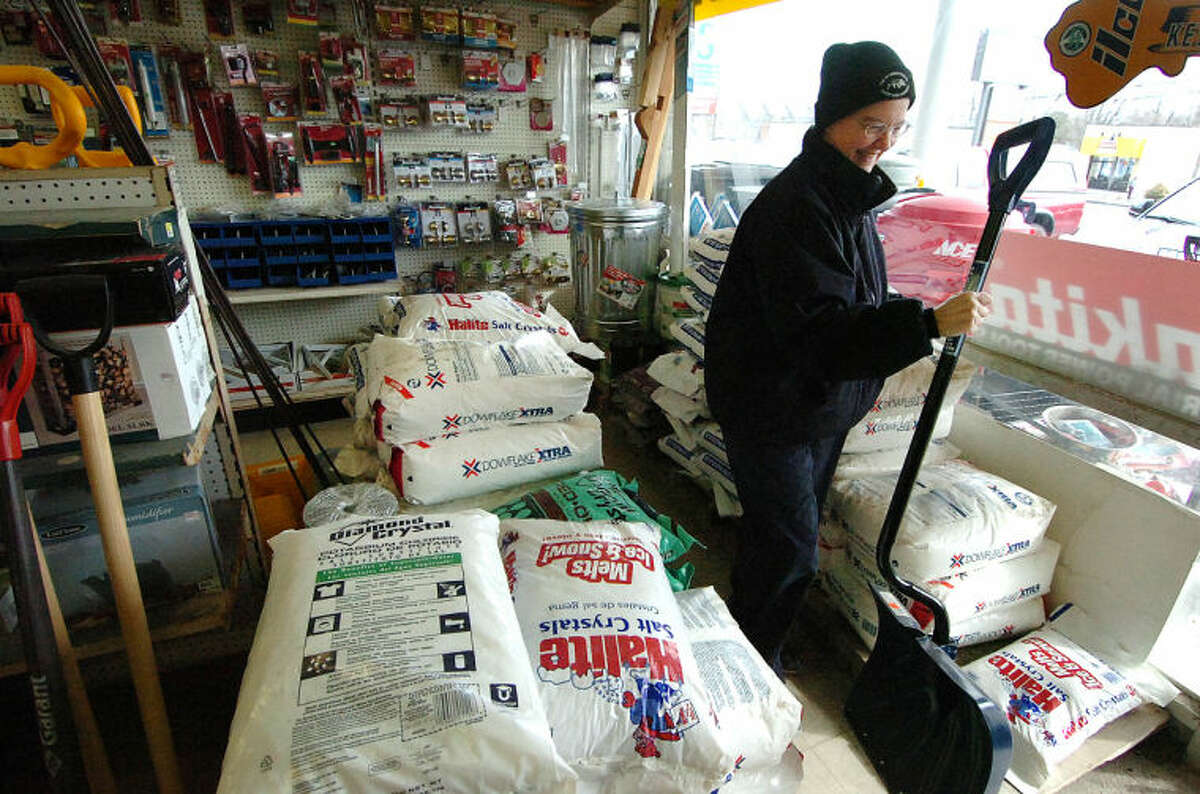 Hour Photo/ Alex von Kleydorff. Kathy Anderson buys a snow shovel at Carlyn hardware on Westport Ave. Business was brisk with area residents preparing for a snow storm and are buying everything thats emergency related. Snow shovels, fireplace wood, gas cans and generators and salt were some of the fast selling items