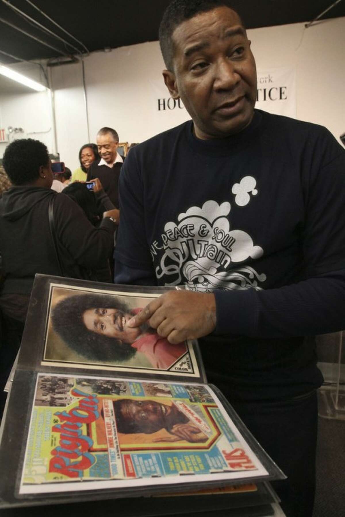 Tyrone Proctor shows a picture of himself from the time when he was a "Soul Train" dancer as he is interviewed following a tribute to "Soul Train" creator Don Cornelius at Rev. Al Sharpton's National Action Network in New York Saturday, Feb. 4, 2012. Cornelius died this week at his Los Angeles home of a self-inflicted gunshot wound. He was 75. (AP Photo/Tina Fineberg)