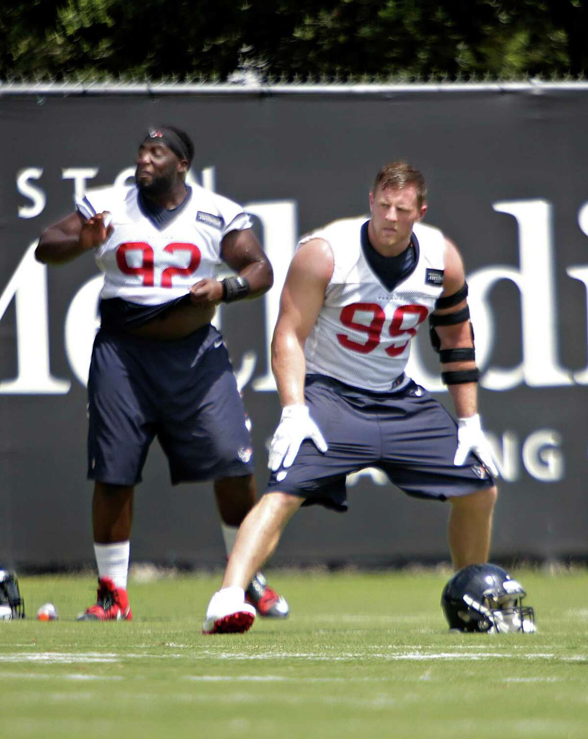 Texans defensive tackle Brandon Dunn and defensive end J.J. Watt stretch during mini camp at the Texans practice facility at NRG Stadium, Tuesday, June 14, 2016, in Houston.