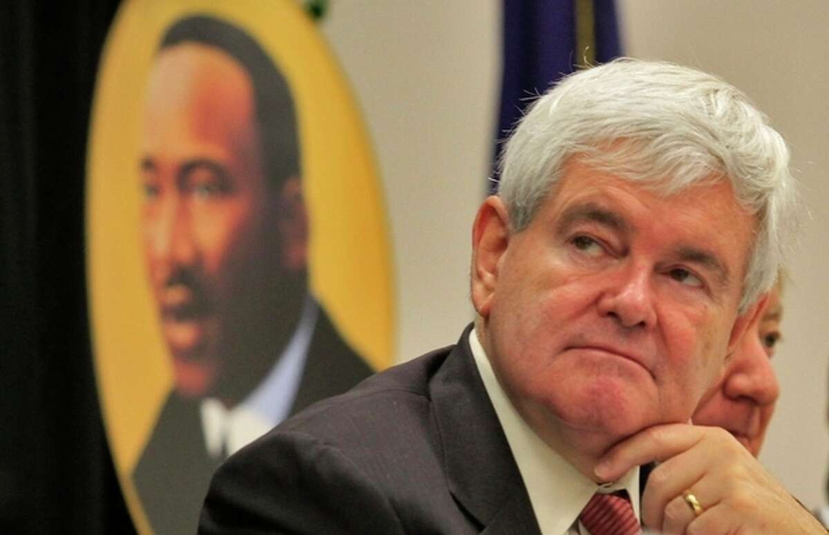 Presidential candidate Newt Gingrich, listens to speakers at the Martin Luther King Jr. celebration breakfast Monday, Jan. 16, 2012 at the Canal Street Recreation Center in Myrtle Beach. (AP Photo/The Sun News, Steve Jessmore)