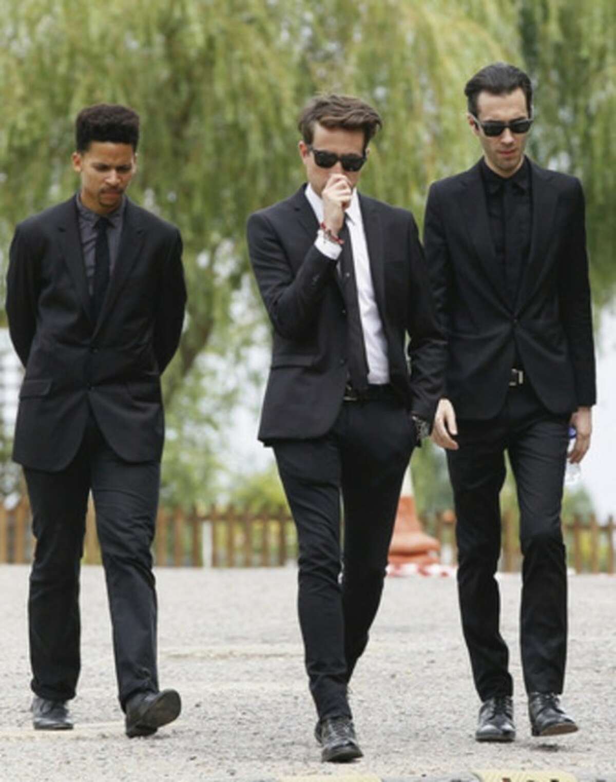 Radio dj Nick Grimshaw, centre, and two other mourners leave Edgwarebury Cemetery, in London, Tuesday July 26, 2011, after attending the funeral of singer Amy Winehouse. The soul diva, who had battled alcohol and drug addiction, was found dead Saturday at her London home. She was 27. (AP Photo/Kirsty Wigglesworth)
