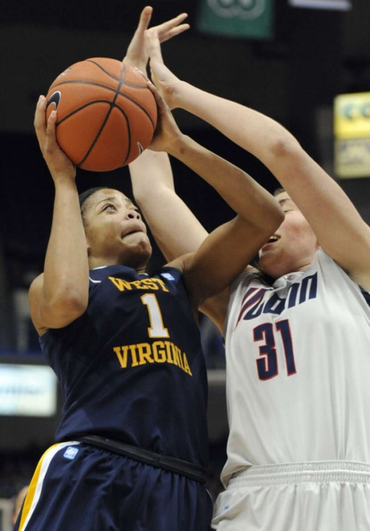 West Virginia's Christal Caldwell, left, is fouled by Connecticut's Stefanie Dolson, right, in the second half of an NCAA college basketball game in Hartford, Conn., Wednesday, Jan. 4, 2012. (AP Photo/Jessica Hill)