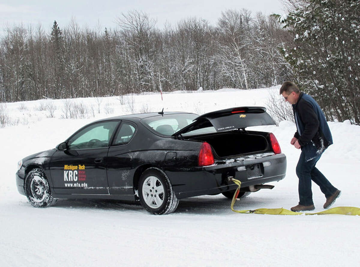 AP Photo/John Flesher In this Jan. 21, 2012 photo, photo Toby Kunnari, an instructor with the Keweenaw Research Center's winter driving school near Hancock, Mich., prepares to detach a towing line from a car that skidded into a snowbank during a training exercise.