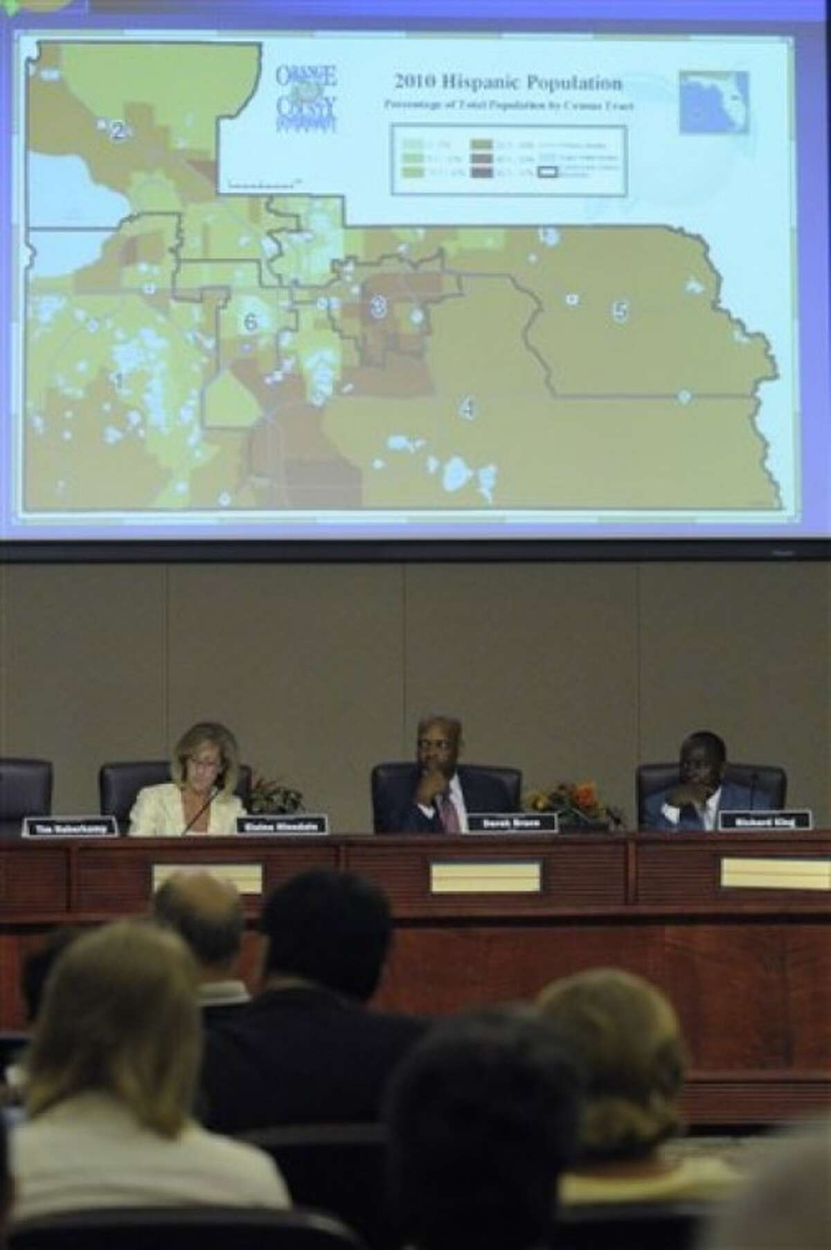 In a April 27, 2011 photo, committee members Elaine Hinsdale, left, Derek Bruce, center, and Richard King listen to a presentation by the supervisor of elections office during a meeting of the Orange County Redistricting Advisory Committee in Orlando, Fla. (AP Photo/Phelan M. Ebenhack)