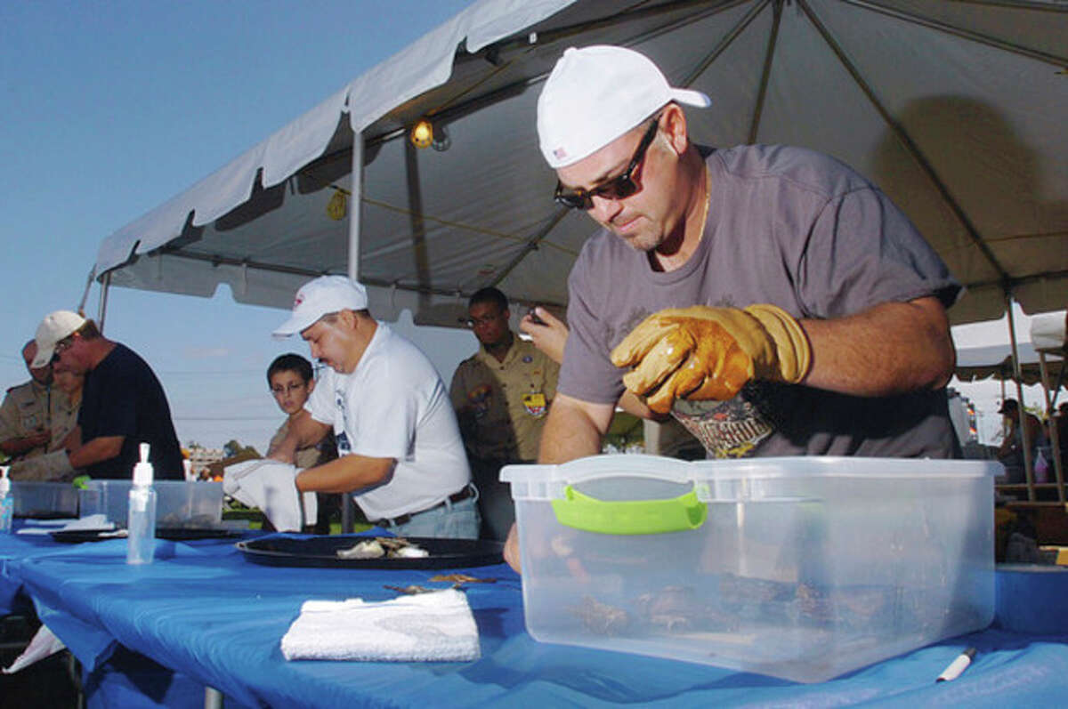 Norwalk resident Claudio Ronzitti competes in the Oyster Shucking Contest at the 2011 Norwalk Seaport Association Oyster Festival Saturday at Veteran's Memorial Park.