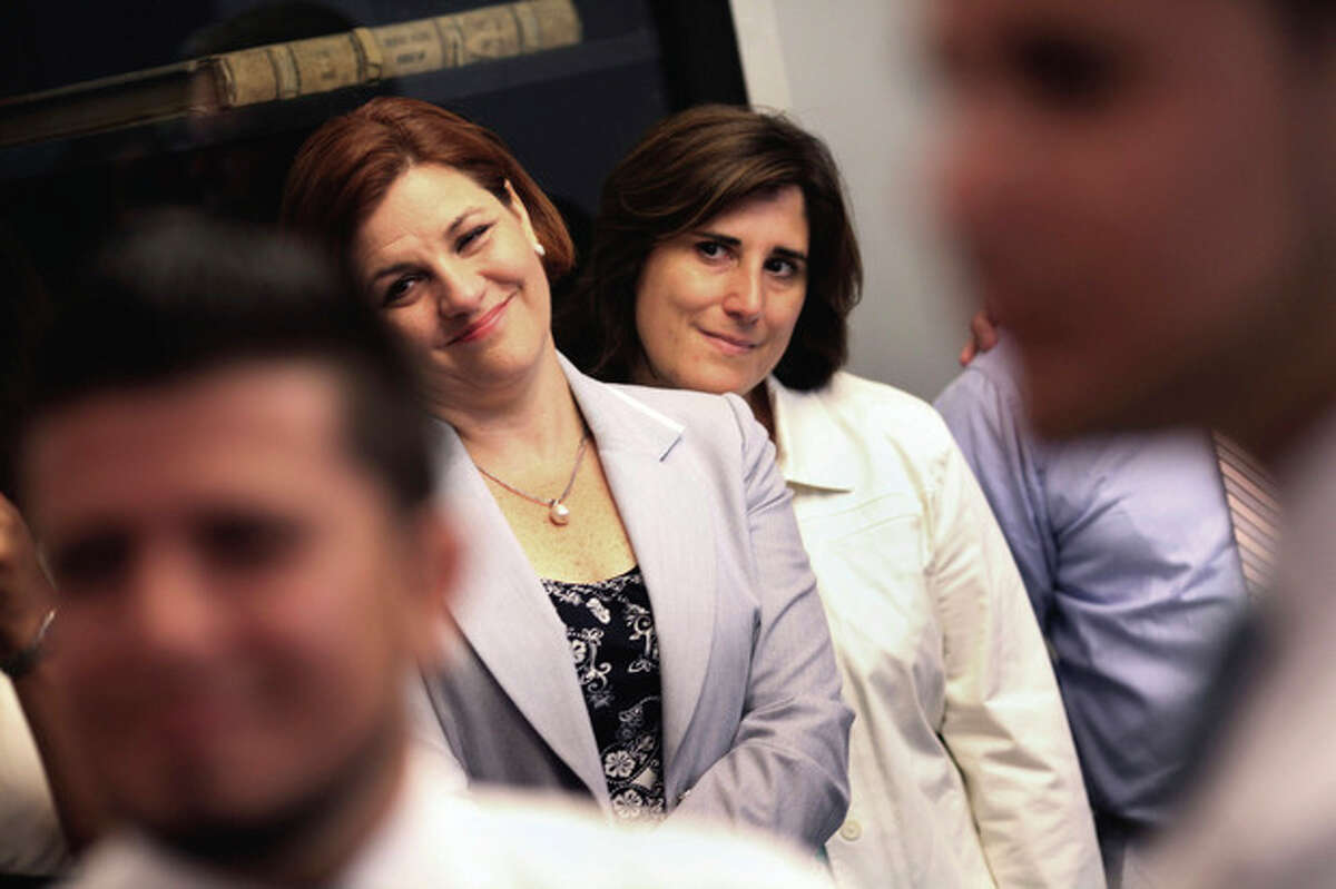ADDS SPEAKER QUINN'S LAST NAME - New York City Council Speaker Christine Quinn, left, and her partner Kim Catullo, attend the wedding of Marcos A. Chaljub and Freddy L. Sambrano at the Manhattan City Clerk's office on the first day New York State's Marriage Equality Act goes into effect, on Sunday, July 24, 2011. (AP Photo/Michael Appleton, Pool)