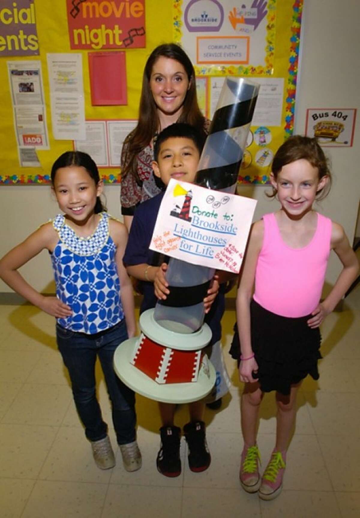 Brookside Elementary School 2nd grade teacher Jennifer Sweeters and 3rd graders Briana Maranon, Andy Velazquez and Caroline Petropolous lead the Brookside Lighthouse for Life team raising money for Relay for Life. Hour photo / Erik Trautmann
