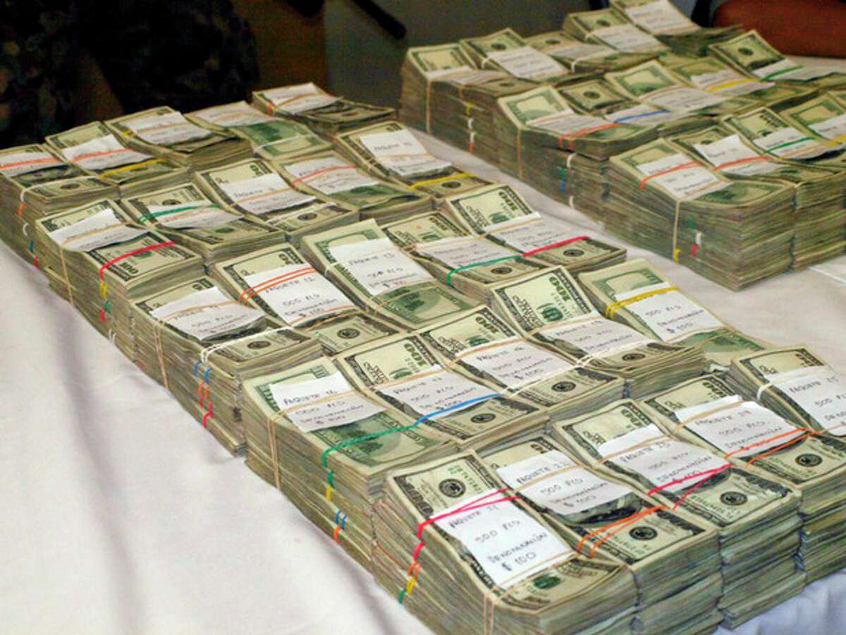 This undated photo, provided by U.S. Immigrations and Customs Enforcement (ICE), shows bulk cash seized during a combined ICE and Homeland Security Investigation (HSI) operation. Immigration agents report a rising number of cash seizures and arrests in the past half-dozen years as criminals, sidestepping scrutiny from banks over electronic transfers, resort to using cash to conceal proceeds from drug trafficking as they move the money south to crime rings in Mexico and elsewhere. (AP Photo/ICE)