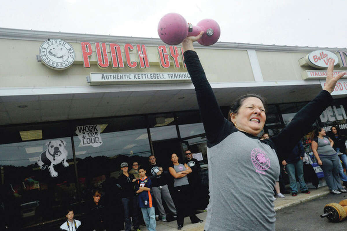 Lillian Tropea, mother of Punch Kettlebell Gym co-owner and head trainer Stefanie Tropea, lifts a dumbbell Sunday during the "Battle of the Belles" strongwoman competition held to benefit the Bennett Cancer Center at Stamford Hospital.