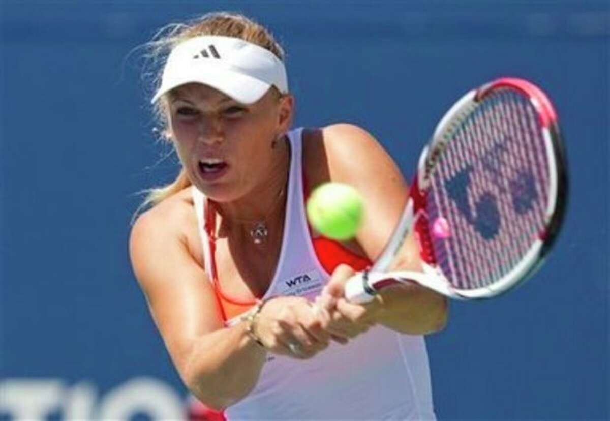 Caroline Wozniacki of Denmark, hits a return during her match against Roberta Vinci of Italy, at the Rogers Cup women's tennis tournament in Toronto on Wednesday, Aug. 10, 2011. (AP Photo/The Canadian Press, Darren Calabrese)