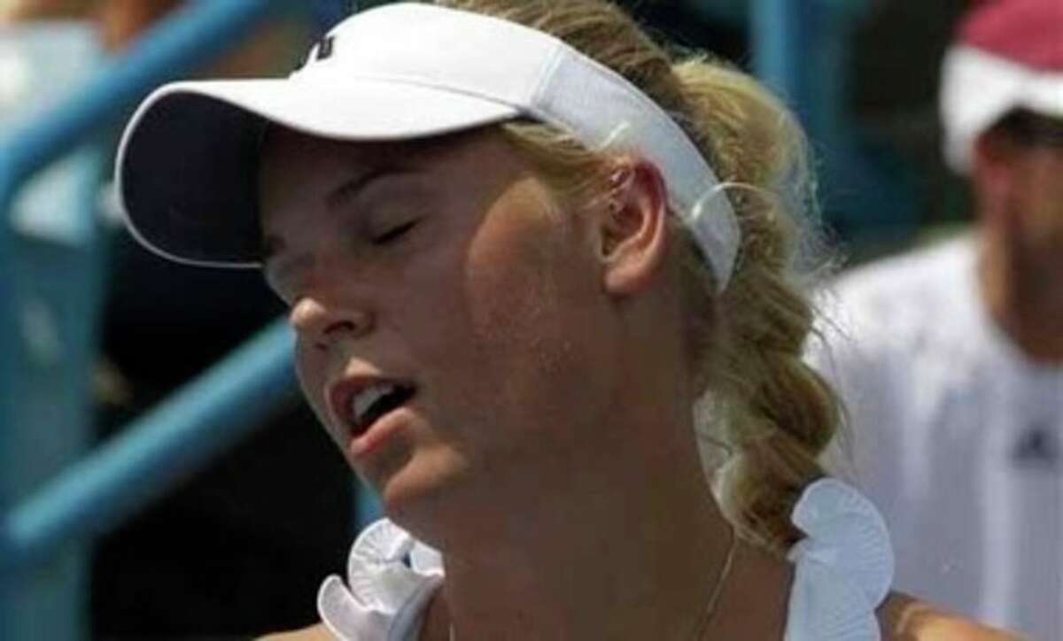 Caroline Wozniacki, from Denmark, reacts after missing a shot during a match against Christina McHale at the Western & Southern Open, Wednesday, Aug. 17, 2011 in Mason, Ohio. McHale upset the top seeded Wozniacki 6-4, 7-5. (AP Photo/Al Behrman)