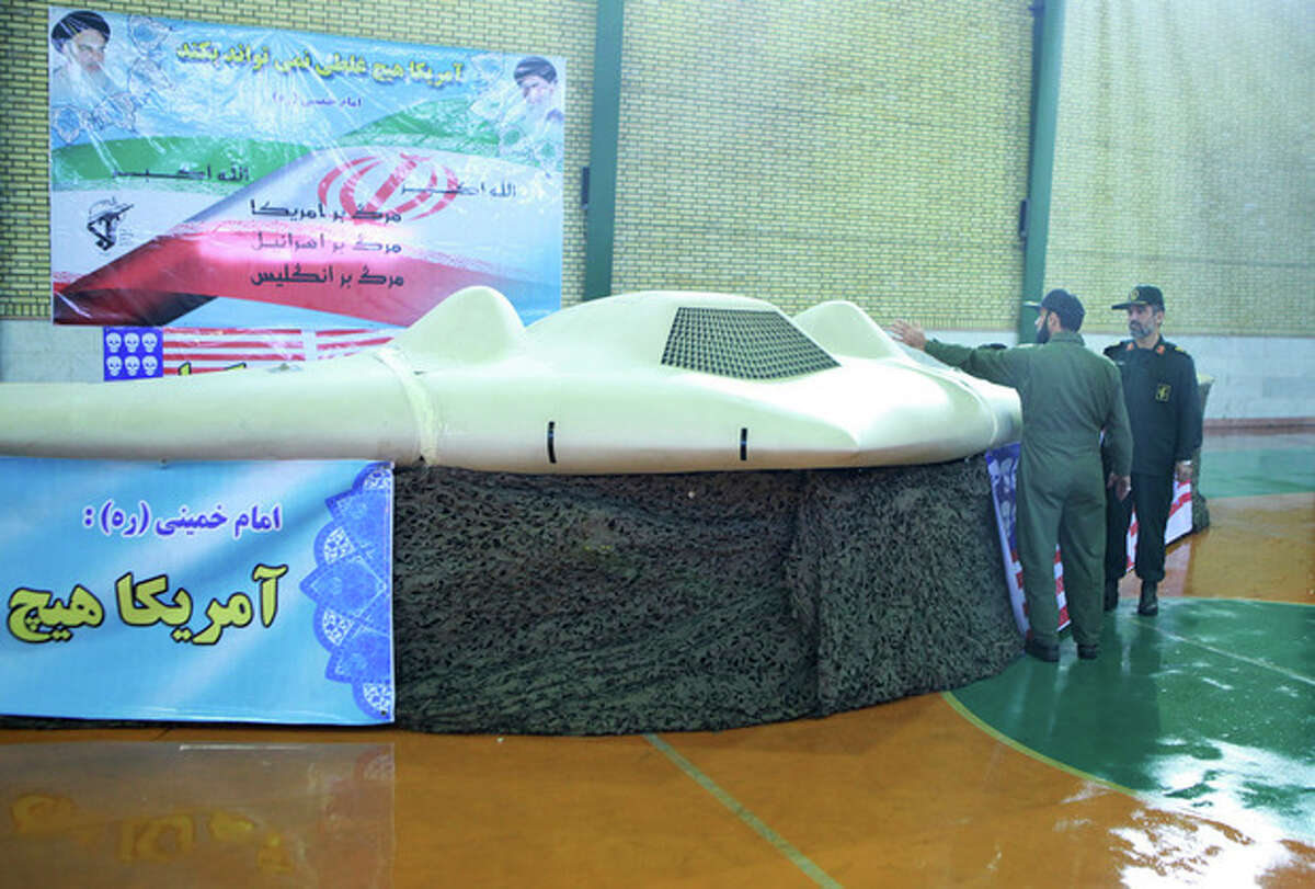 FILE - This file photo released on Thursday, Dec. 8, 2011, by the Iranian Revolutionary Guards, claims to show US RQ-170 Sentinel drone which Tehran says its forces downed earlier this week, as the chief of the aerospace division of Iran's Revolutionary Guards, Gen. Amir Ali Hajizadeh, right, listens to an unidentified colonel, in an undisclosed location, Iran. Iran's semiofficial Fars news agency said Thursday, April 18, 2012 that Russia and China have asked Tehran to provide them with information on a U.S. drone captured by the Islamic Republic in December. (AP Photo/Sepahnews, File) EDS NOTE: THE ASSOCIATED PRESS HAS NO WAY OF INDEPENDENTLY VERIFYING THE CONTENT, LOCATION OR DATE OF THIS IMAGE.