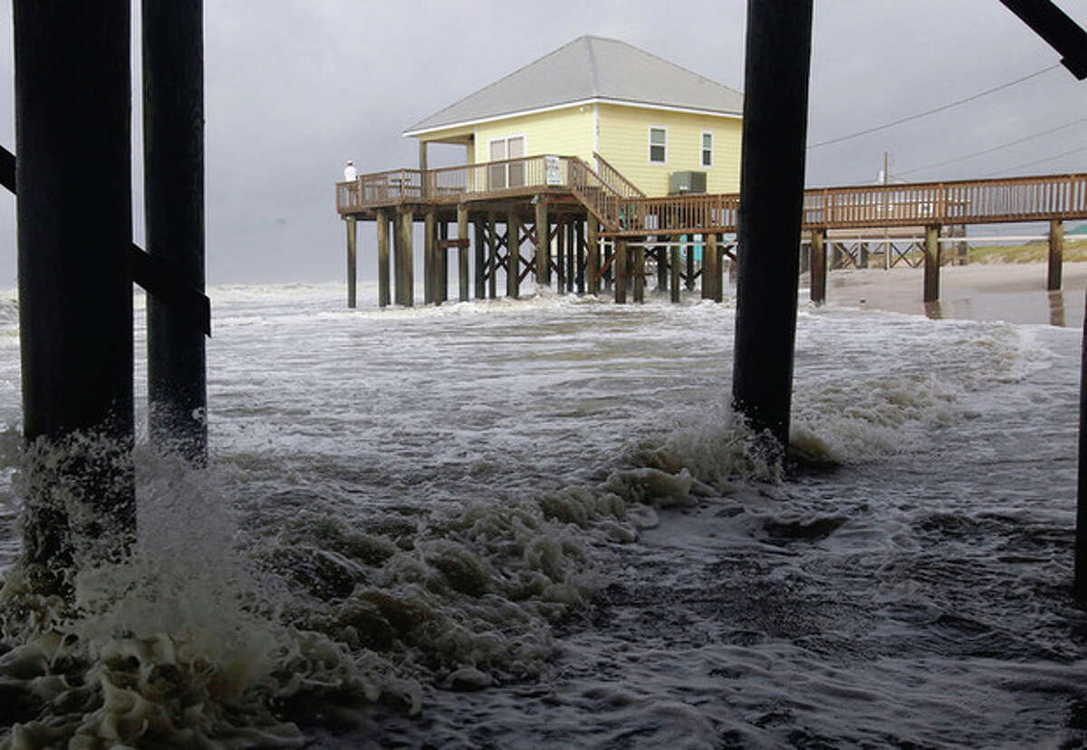 AP Photo/Dave Martin High surf rushes under houses along the west end of Dauphin Island, Ala., early Sunday. Tropical Storm Lee is continuing to meander along the Gulf Coast bring torrential rains and flooding.