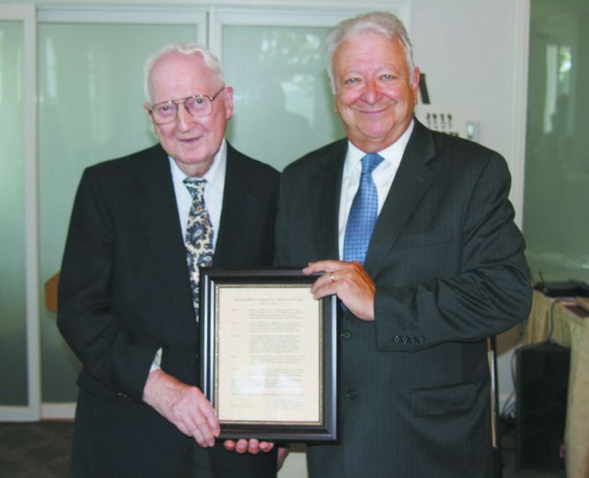 Abbott White, left, founder of Norwalk/Wilton AARP Chapter 3929, receives a framed proclamation from Norwalk Mayor Richard Moccia. The proclamation is in honor of the chapters 25th anniversary.
