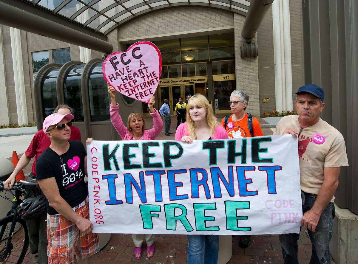 (FILES) In this May 15, 2014 file photo, protesters hold a rally at the Federal Communications Commission(FCC) in Washington, DC to support "net neutrality." The top US telecom regulator FCC announced February 4, 2015 he would propose to regulate the Internet as a public utility, as part of a renewed effort to enforce "net neutrality" rules. Federal Communications Commission chairman Tom Wheeler unveiled the plan which aims to prevent Internet providers from playing favorites or blocking some services or allowing others to pay for "fast lanes." The new proposal comes a year after a federal court struck down the FCC neutrality rules, saying it lacked the authority because Internet providers were not "common carriers" under US telecom law. The plan, which is expected to unleash a fresh legal and political battle, aims to resolve the impasse by reclassifying Internet service providers as regulated entities under the 1934 Telecommunications Act. AFP PHOTO / Karen BLEIER / FILESKAREN BLEIER/AFP/Getty Images