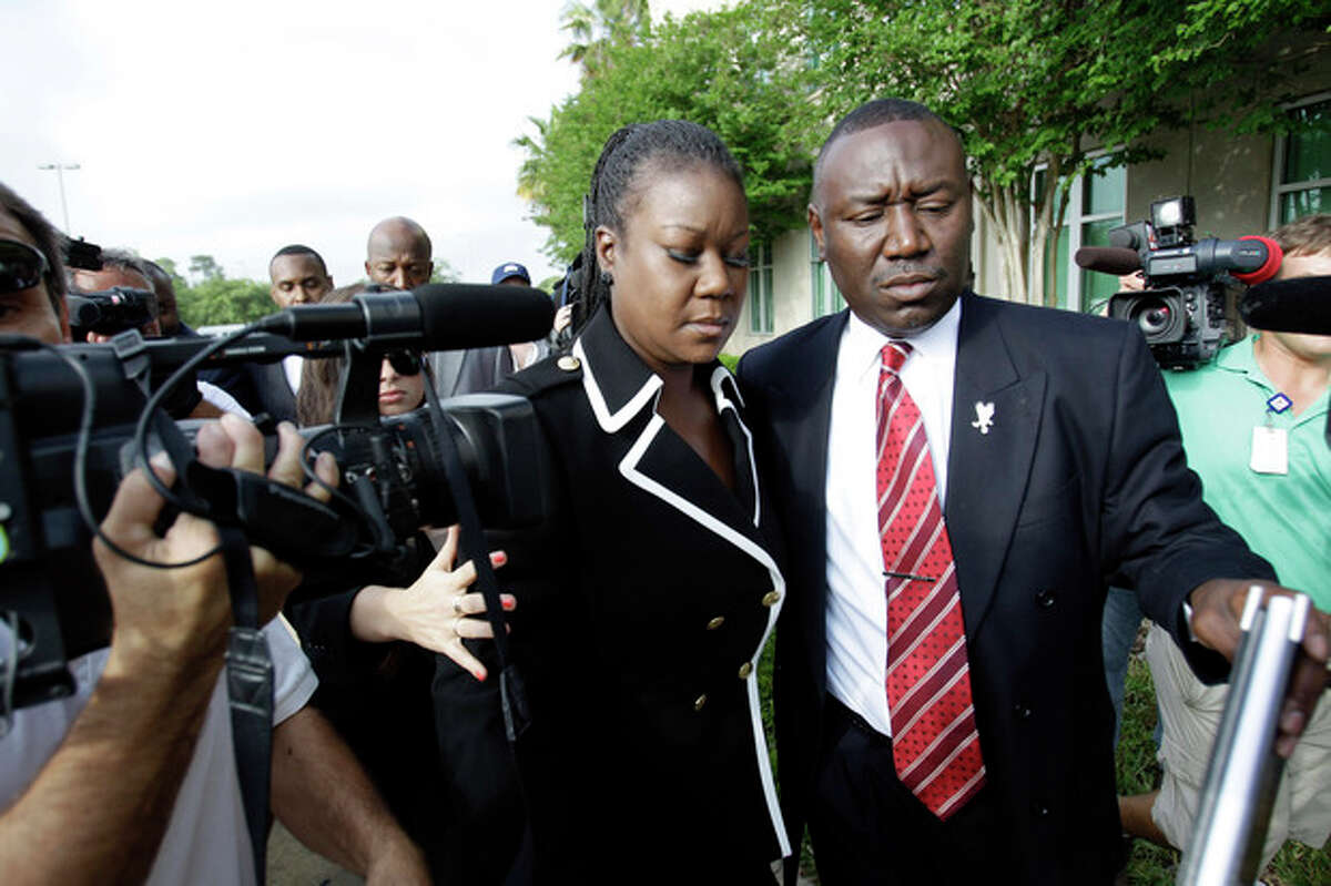 Sybrina Fulton, left, mother of Trayvon Martin and attorney Benjamin Crump, arrive at the Seminole County Criminal Justice Center for a bond hearing for George Zimmerman, the neighborhood watch volunteer charged with murdering Trayvon Martin, Friday, April 20, 2012, in Sanford, Fla. Zimmerman's attorney is asking the Seminole County judge to let Zimmerman post bail at the hearing Friday. (AP Photo/John Raoux)