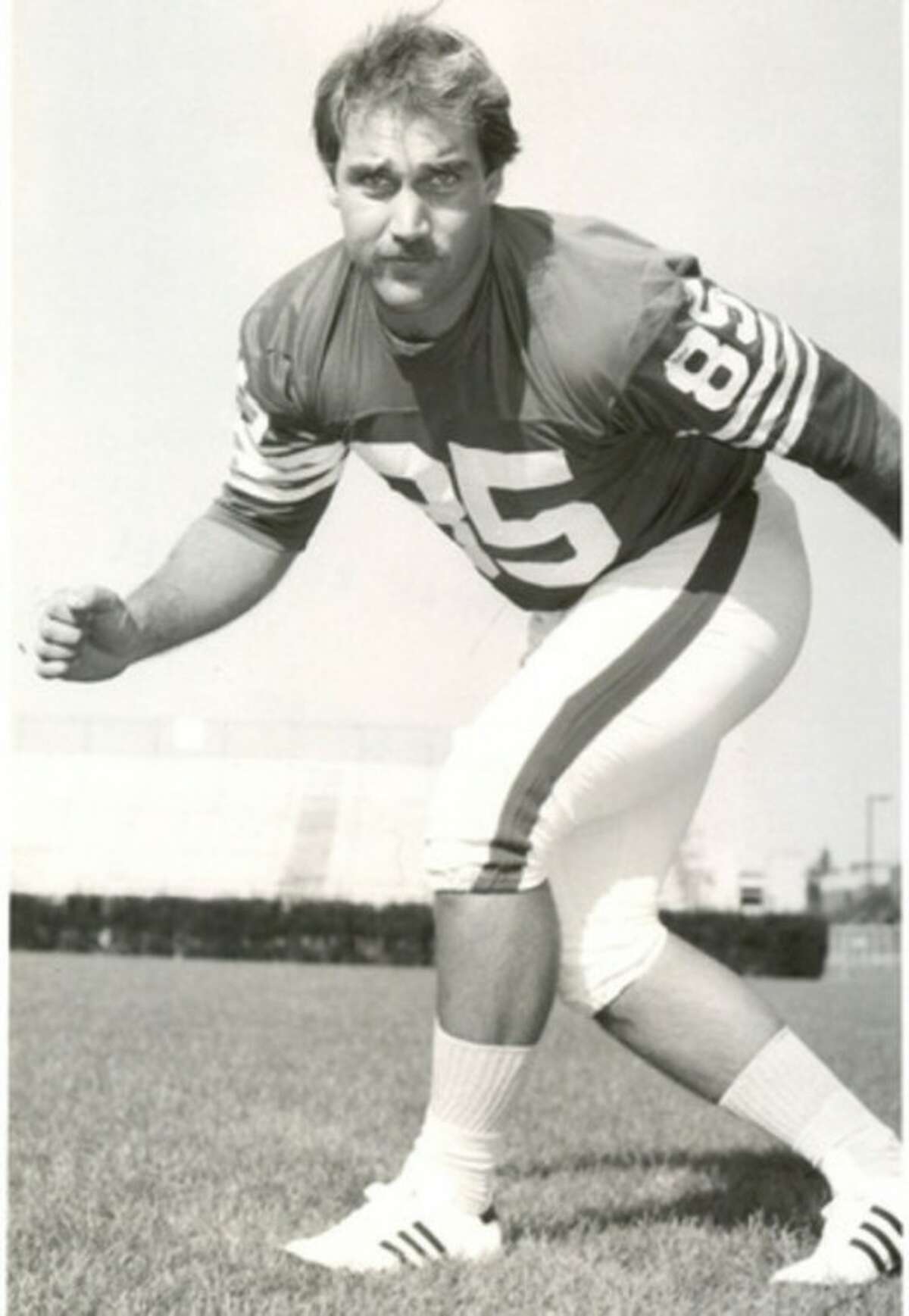Photo courtesy of UConn Athletic Communications Norwalk's Dewey Raymond, seen in his playing days, will be one of the honorary captains for this Saturday's Blue-White game at the University of Connecticut.