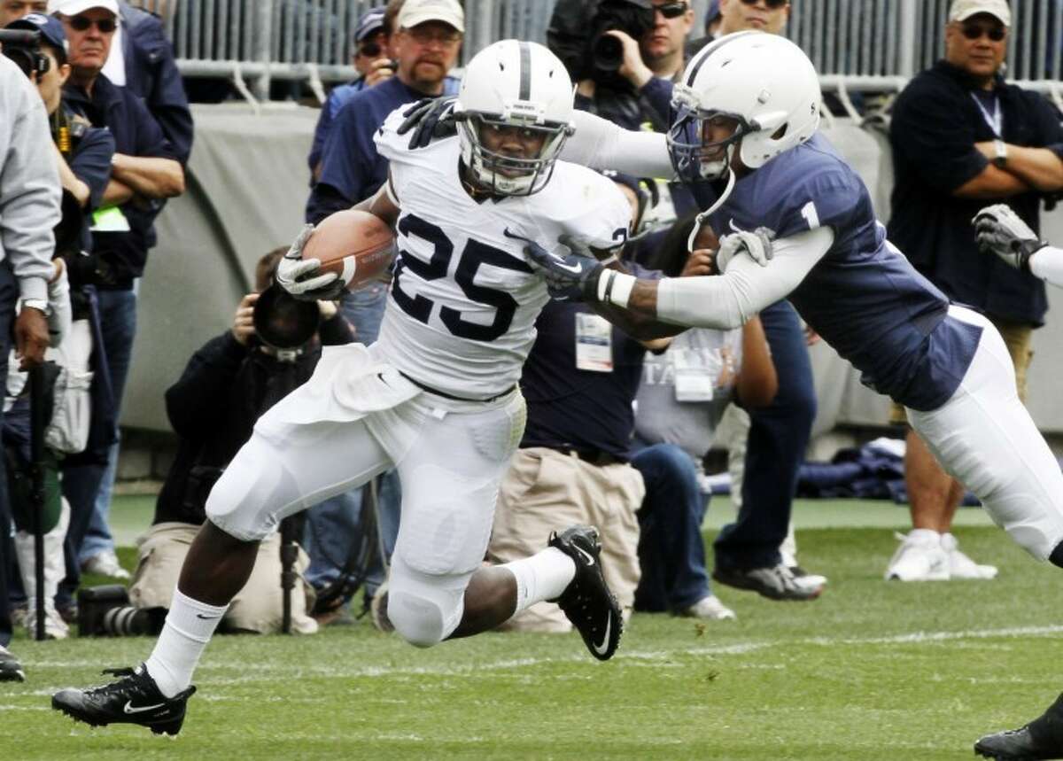 Penn State running back Silas Redd (25), a resident of Norwalk who played his high school ball at King Low Heywood Thomas in Stamford, tries to fend off cornerback Thomas Derrick (1) during their spring NCAA college football game, Saturday, April 21, 2012, in State College, Pa. (AP Photo/Keith Srakocic)