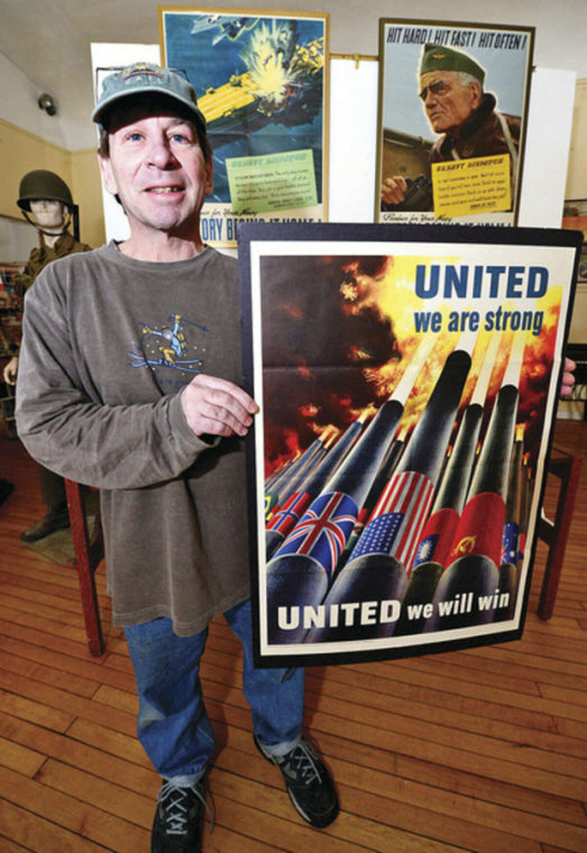 Contributor Roger Raffini helped with the hundreds of magazines, posters, photos and propaganda from the World War II era that are on display at the Georgetown Community Association Center, where many of the exhibitions are taken from area Wilton residents' personal collections. Hour photo / Erik Trautmann
